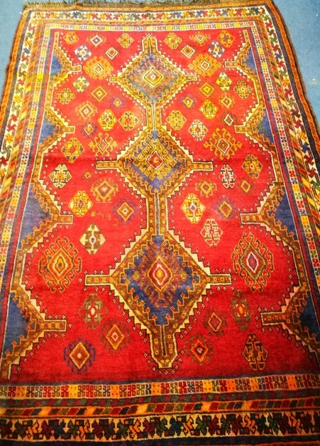 A Shiraz red ground rug 236 x 165cm